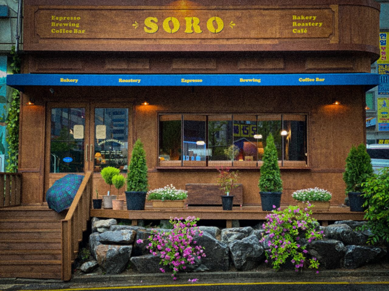 The SORO storefront in Ansan, framed by flowers and greenery